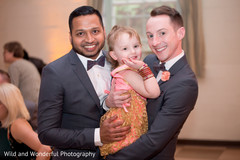 Happy same sex Indian couple with the flower girl. Happy same sex Indian couple with the flower girl.