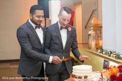 Gay Indian wedding reception cake cutting scene. Gay Indian wedding reception cake cutting scene.