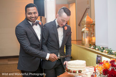 Enchanting gay Indian wedding cake cutting moment. Enchanting gay Indian wedding cake cutting moment.