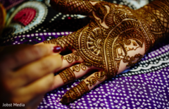 Indian bride getting bridal mehndi art done Indian bride getting bridal mehndi art done