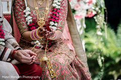 Indian bride and groom holding rose petals during wedding ceremony indian wedding ceremony,traditional indian wedding ceremony,bridal lengha