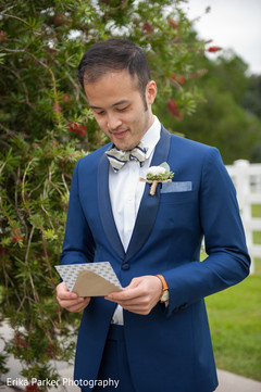 Indian groom reading a letter before wedding ceremony Indian groom reading a letter before wedding ceremony