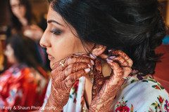 Maharani putting her earrings on Maharani putting her earrings on