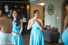 Sweet bridesmaids helping bride getting ready Sweet bridesmaids helping bride getting ready