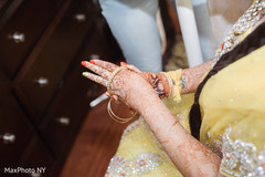 Indian bride putting bridal jewelry on Indian bride putting bridal jewelry on