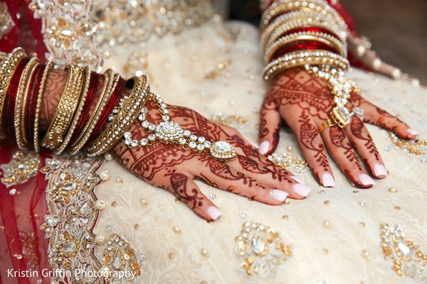 Indian bridal hand mehndi and jewelry.