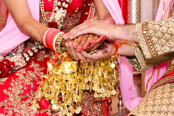 Indian bride and groom holding hands