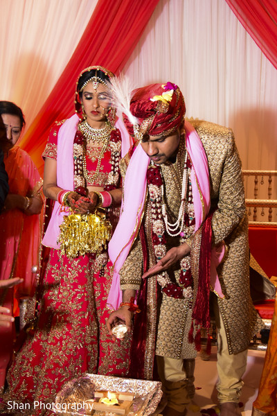 Indian groom making offerings to holy fire