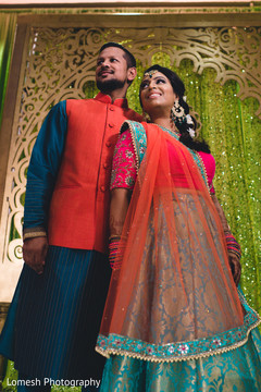 Indian bride and groom in their sangeet outfits pre- wedding celebrations,sangeet,indian bride fashion,indian groom fashion