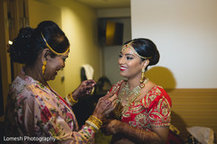 Indian mother helping bride getting ready indian bride getting ready,indian bride hair and makeup,bridal jewelry,bridal tikka