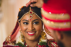Lovely indian bride looking at groom indian destination wedding,bridal jewelry,bridal tikka