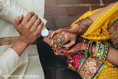Indian bride and groom holding hands bridal jewelry,mehndi art,pre- wedding celebrations
