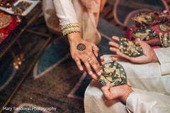 Indian bride and groom holding betel leaves on their hands pre- wedding celebrations,indian bride,indian groom