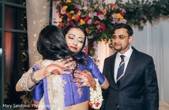 Indian bride being hugged during wedding ceremony indian wedding ceremony,indian groom suit,indian bride