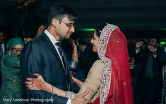 Indian bride and groom dancing together at their wedding reception indian bride fashion,indian groom suit,indian wedding reception,dj and entertainment