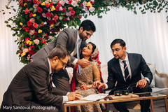 Indian bride and groom signing wedding contract indian wedding ceremony,indian wedding ceremony floral and decor,indian groom suit,indian bride fashion