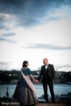 Indian bride and groom holding hands indian bride lengha,indian groom suit,outdoor photography