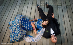 Indian bride and groom lying down indian groom suit,indian bride lengha,indian bride and groom