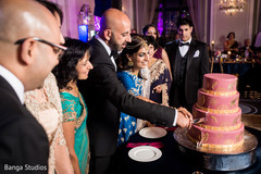 Indian bride and groom cutting the cake indian groom suit,indian bride fashion,indian wedding reception,indian wedding cake