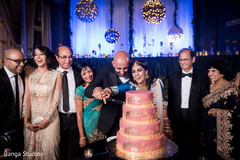 Lovely indian couple cutting the wedding cake indian wedding cake,indian wedding cake design,indian wedding reception