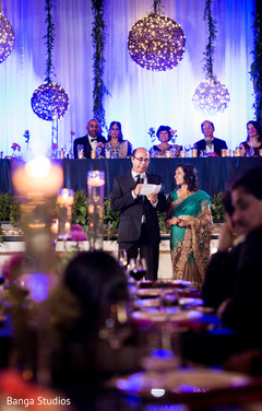 Indian groom's parents giving a speech indian wedding reception,indian wedding reception decor,lightning
