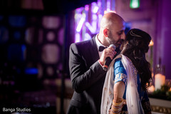 Indian groom kissing bride's cheek indian wedding reception,indian bride lengha,indian groom suit,bridal jewelry