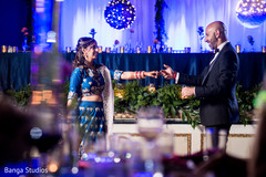 Indian bride and groom smiling and looking at each other indian groom suit,indian bride lengha,indian wedding reception