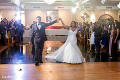 Happy couple entering the wedding reception. iindian bride and groom,indian wedding reception,dj