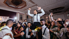 Indian Groom being lifted up in the air Indian Groom being lifted up in the air