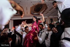 Indian bride being lifted up in the air Indian bride being lifted up in the air