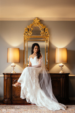 Indian bride in white dress posing for photo shoot Indian bride in white dress posing for photo shoot