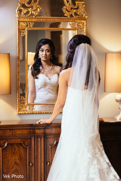Lovely indian bride looking herself at the mirror indian bride fashion,indian bride getting ready,indian bride hair and makeup