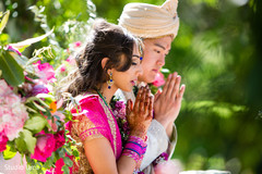 Indian bride and groom making a prayer Indian bride and groom making a prayer
