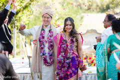 Indian bride and groom leaving wedding ceremony Indian bride and groom leaving wedding ceremony