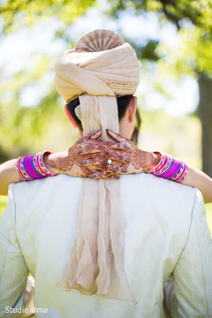 Indian bride putting hands with mehndi decoration on grooms neck mehndi art,indian bridal mehndi,bridal jewelry