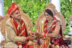 Indian bride and groom smiling during wedding ceremony indian bride lengha,indian groom sherwani,indian groom turban,bridal jewelry