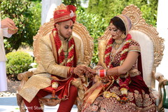Indian groom putting wedding ring on bride's finger indian wedding ceremony,indian groom sherwani,indian groom turban,indian bride lengha