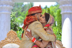 Indian bride and groom hugging indian wedding ceremony,indian groom sherwani,indian bride fashion,bridal jewelry