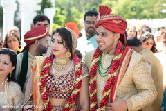 Lovely indian couple during wedding ceremony indian groom sherwani,indian bride lengha,bridal jewelry,indian wedding ceremony