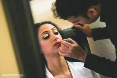 Beautiful indian bride being dolled up for her ceremony