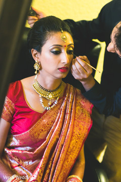 Indian bride getting makeup done
