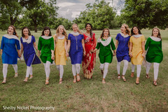 Indian bride with bridesmaids holding hands Indian bride with bridesmaids holding hands