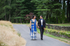 Glamorous Indian bride and groom in blue reception outfits. Glamorous Indian bride and groom in blue reception outfits.