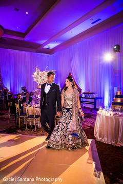 Indian bride and groom arriving at their wedding reception indian bride reception fashion,indian groom suit,indian wedding reception
