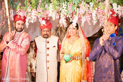 Indian bride walking down the aisle under a flower canopy. Indian bride walking down the aisle under a flower canopy.
