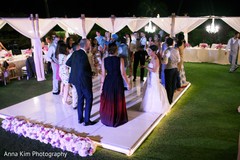 Indian bride and groom dancing with guests indian wedding reception,dj and entertainment,monogrammed dance floor.