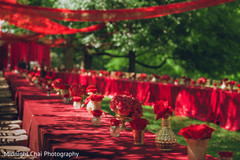 Scarlet linens with arrangements of roses and hydrangeas. Scarlet linens with arrangements of roses and hydrangeas.