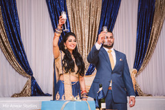 Indian bride and groom making a toast indian wedding reception,indian bride reception fashion,indian groom suit