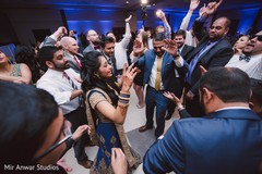 Indian bride and groom dancing with guests indian groom suit,indian bride reception fashion,indian wedding reception,dj and entertainment