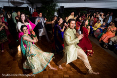 Indian bride and groom dancing on sangeet night Indian bride and groom dancing on sangeet night